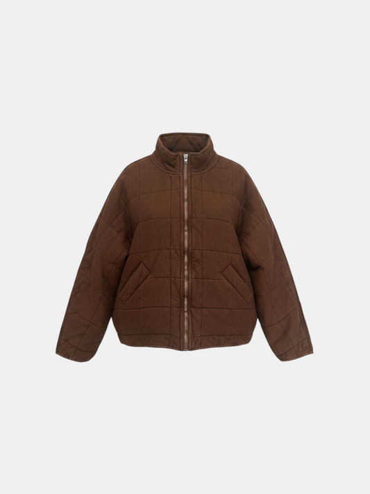 THE FASHION LIBRARY Free People brown quilted zip-up jacket with a stand collar and front pockets.